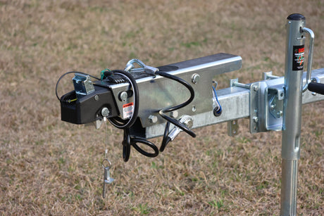EZ Loader trailer brake actuator mounted on tongue showing surge brake system and safety chains