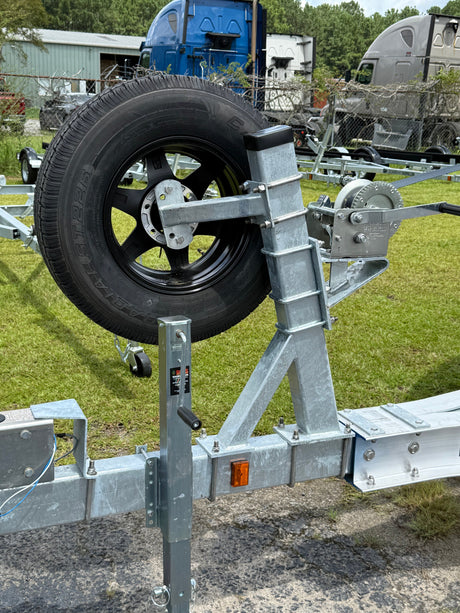 EZ Loader trailer spare tire carrier mounted on frame holding wheel above waterline for marine use