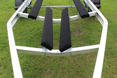 EZ Loader boat trailer crossmember supporting bunk brackets and carpeted bunks on aluminum trailer frame