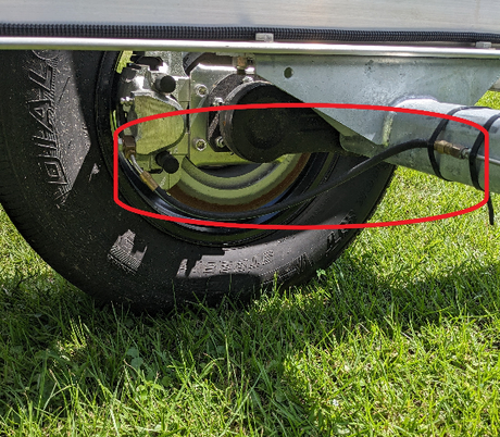 EZ Loader Torsion axle hydraulic hose shown mated to caliper on trailer for display location need